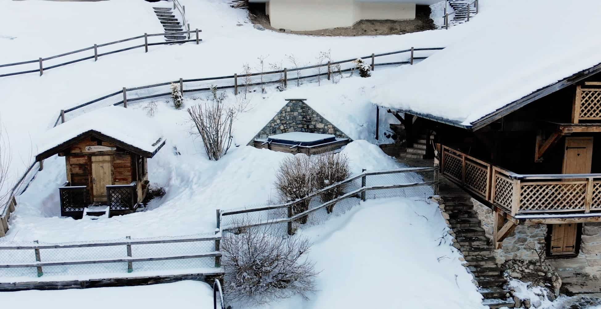 an aerial view of the clarian chalets hot tub in winter in the snow
