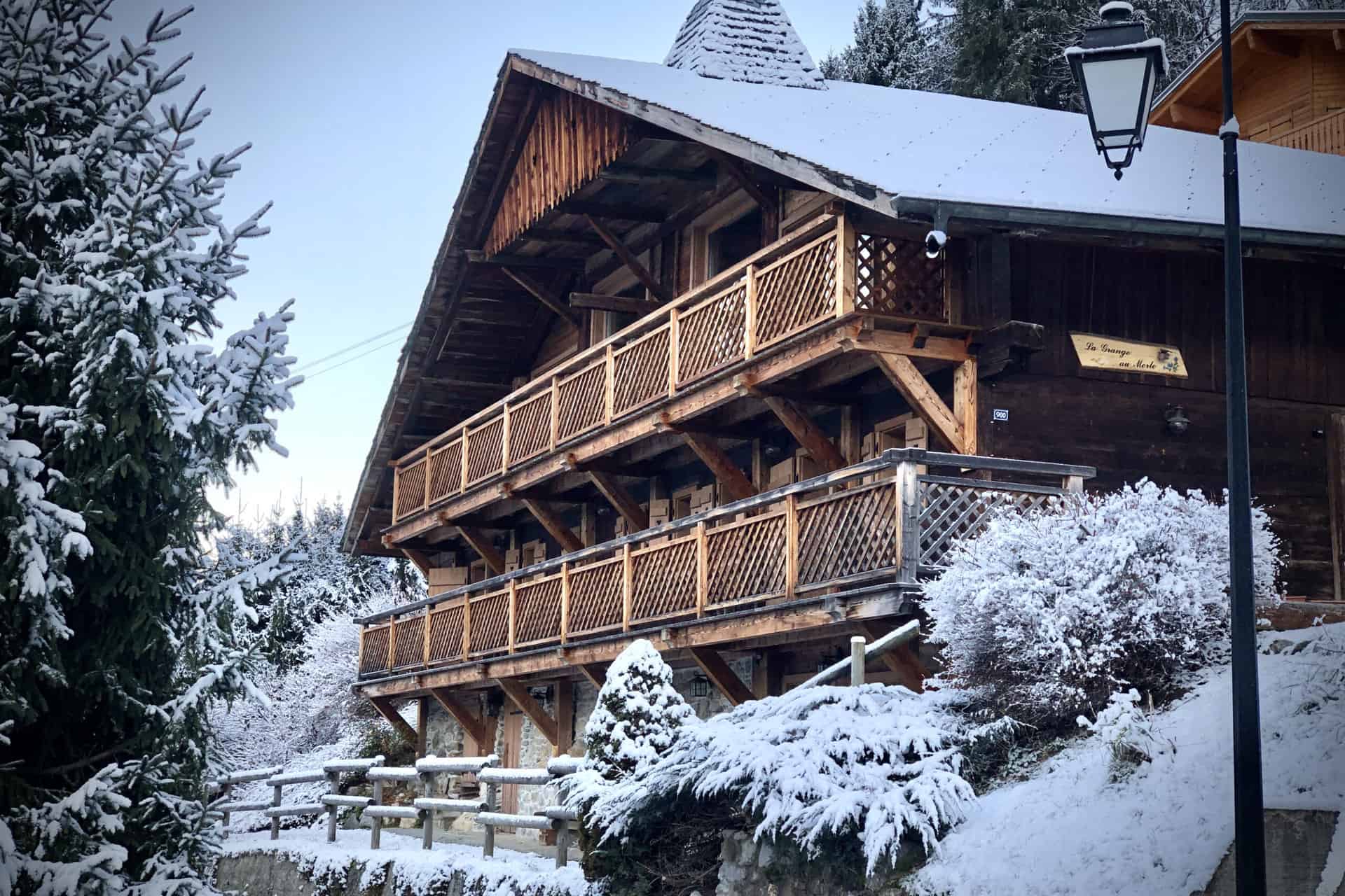 front view of the chalet from the road in the snow