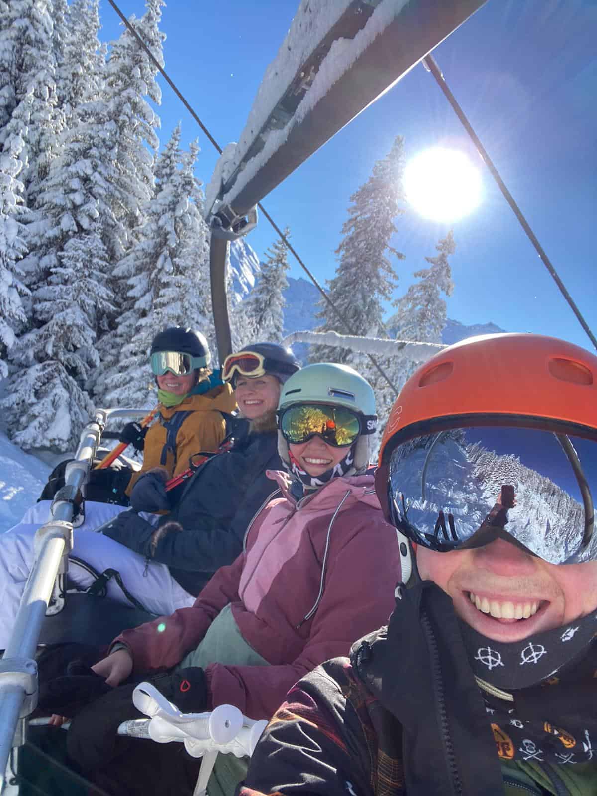 ski chalet hosts on chairlift in sunshine