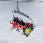 family sitting on chairlift